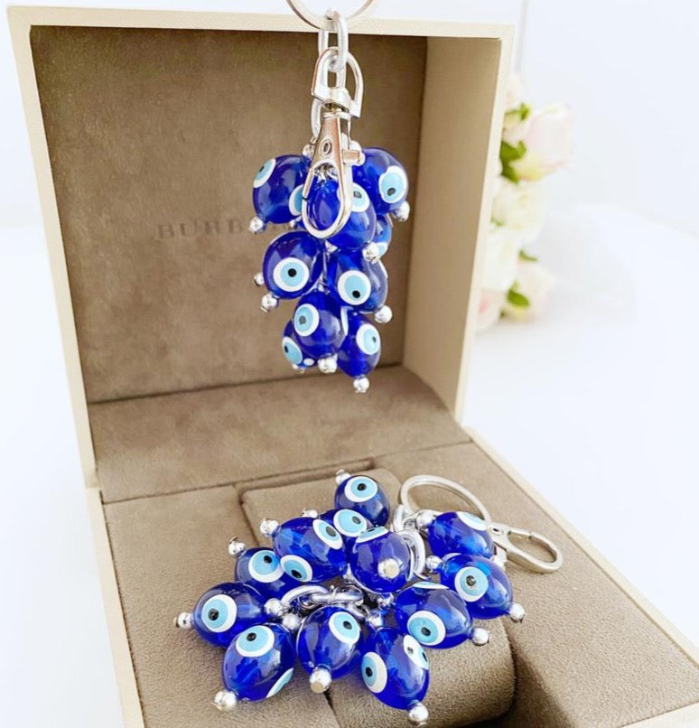 A stylish blue evil eye bead keychain featuring resin beads and an enamel keychain, symbolizing protection and good luck.