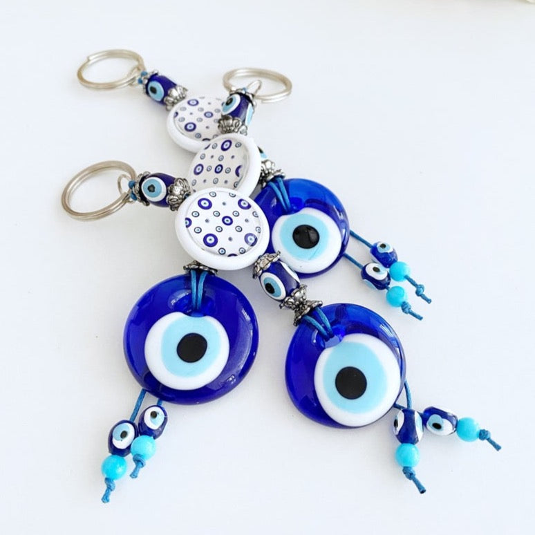 A beautiful blue evil eye bead keychain, symbolizing protection and luck, elegantly designed with a sturdy keyring.