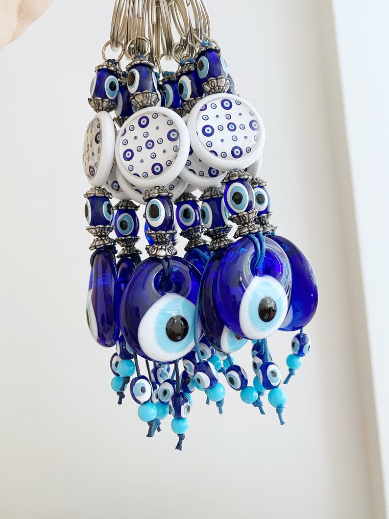 A beautiful blue evil eye bead keychain, symbolizing protection and luck, elegantly designed with a sturdy keyring.