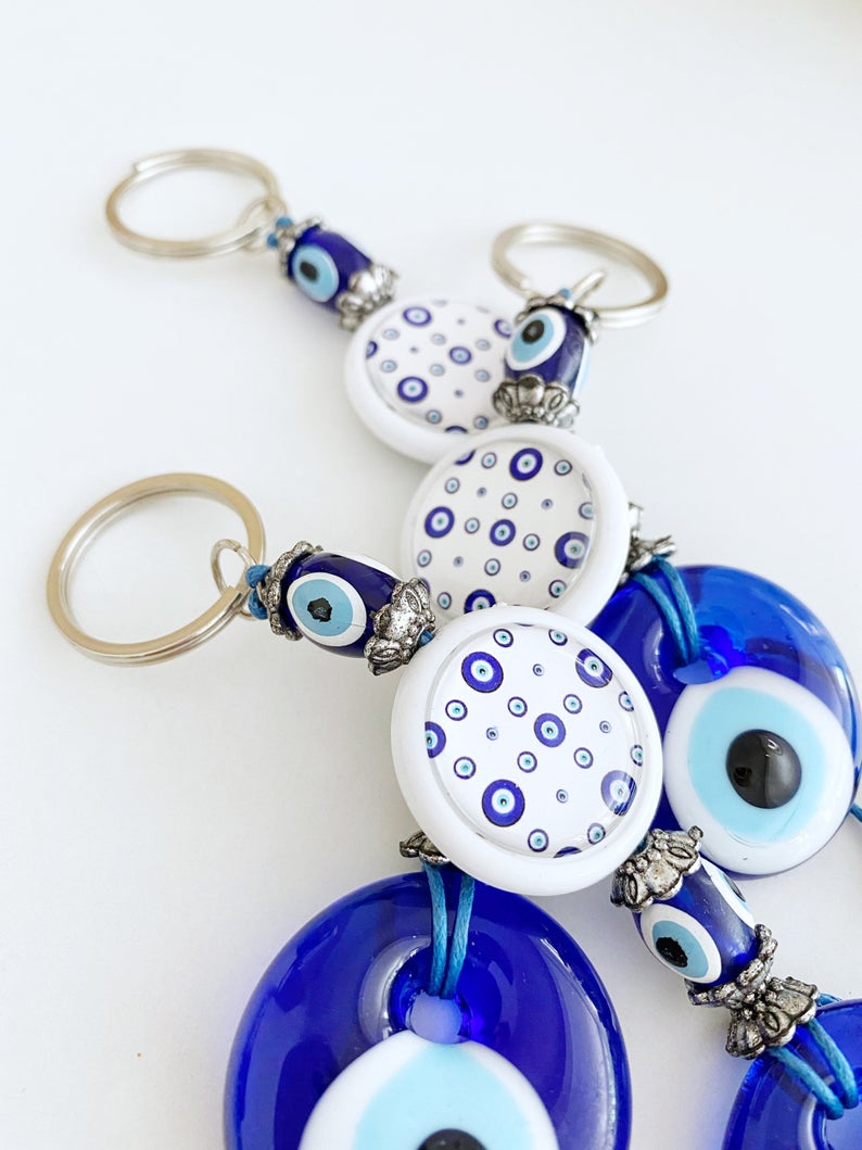 A beautiful blue evil eye bead keychain, symbolizing protection and luck, elegantly designed with a sturdy keyring.