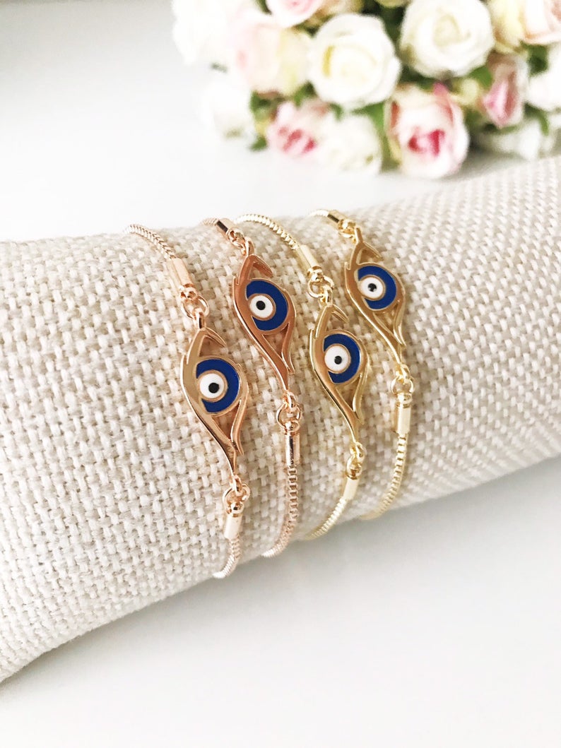 A beautiful blue evil eye bracelet in rose gold, featuring an adjustable design and a striking evil eye charm.