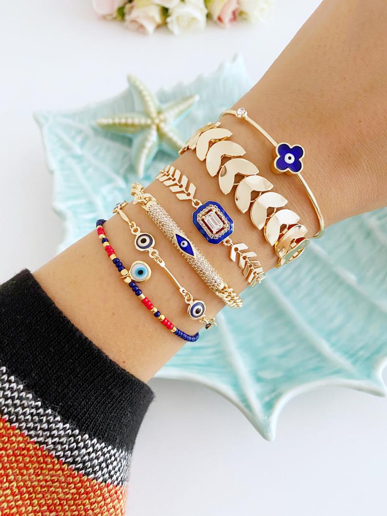 A beautiful Blue Evil Eye Bracelet featuring a gold chain and adjustable design, handmade with 316L stainless steel.