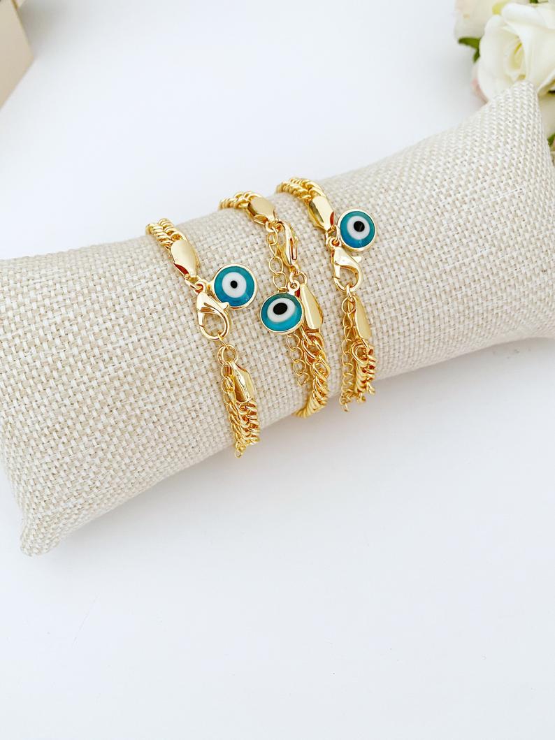 A beautiful Blue Evil Eye Bracelet featuring handmade blue beads and a chunky gold chain, symbolizing protection and good luck.