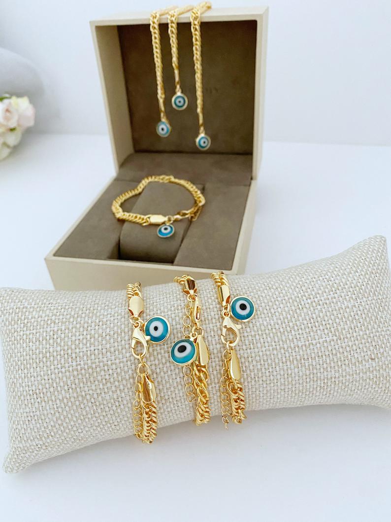 A beautiful Blue Evil Eye Bracelet featuring handmade blue beads and a chunky gold chain, symbolizing protection and good luck.