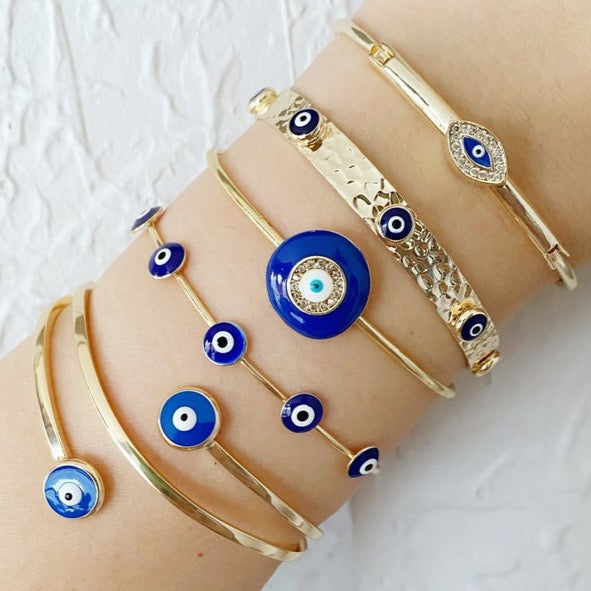 A beautiful handmade Blue Evil Eye Bracelet featuring a gold cuff design, showcasing intricate details and a protective blue eye symbol.