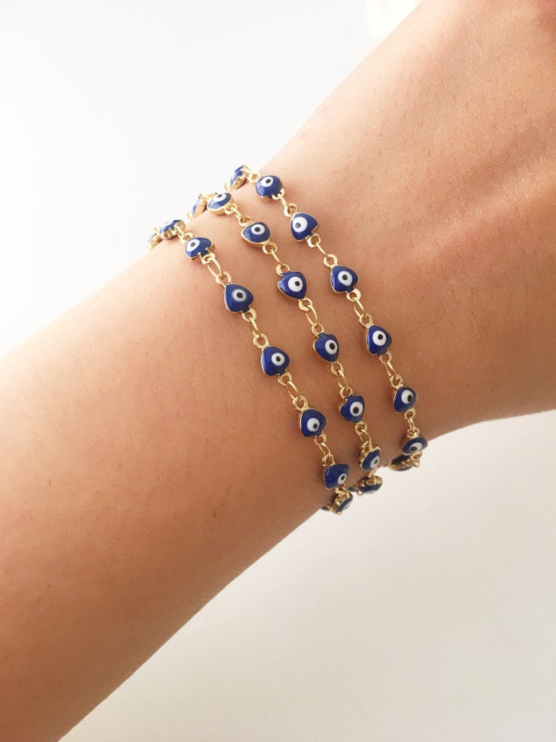 A stylish Blue Evil Eye Bracelet featuring 4mm blue evil eye beads on a minimalist gold chain, perfect for protection and fashion.