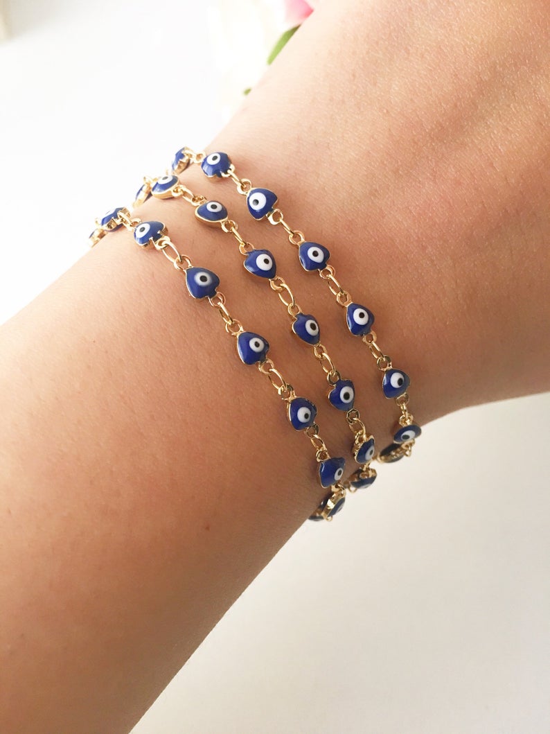 A stylish Blue Evil Eye Bracelet featuring 4mm blue evil eye beads on a minimalist gold chain, perfect for protection and fashion.