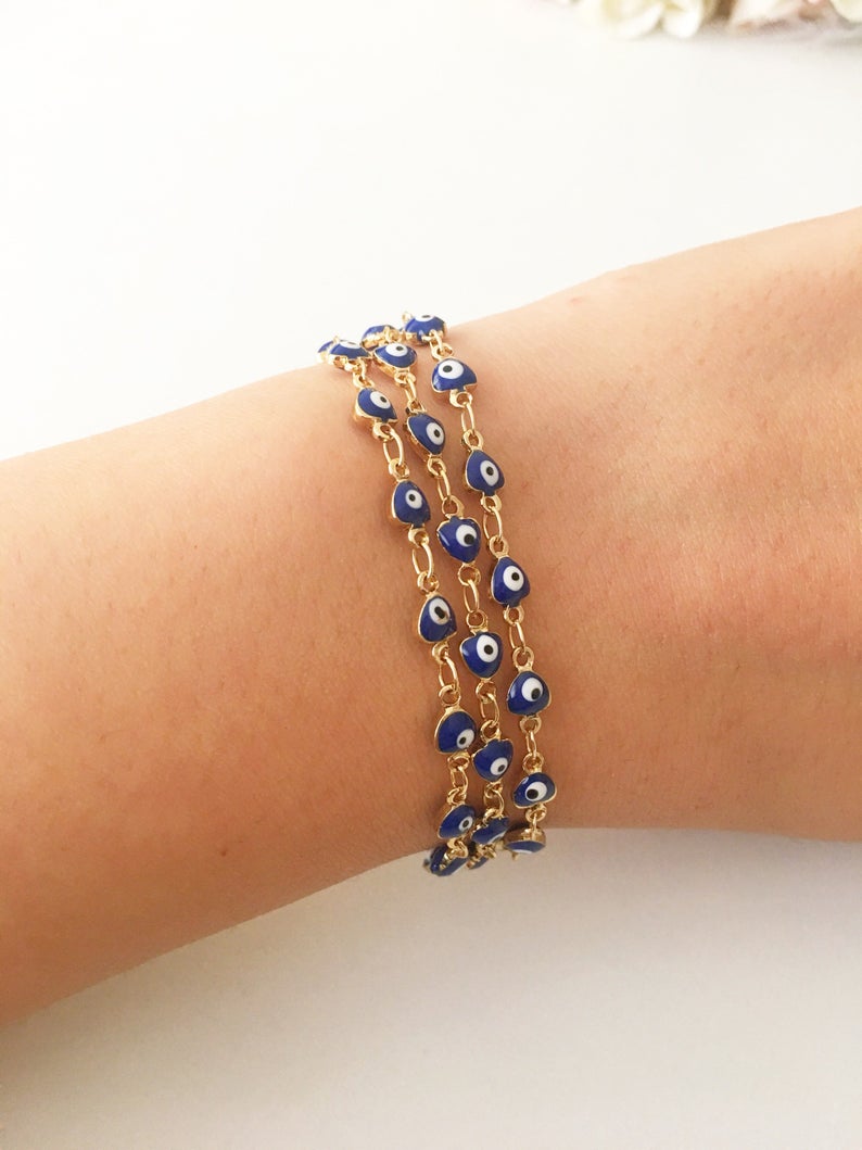 A stylish Blue Evil Eye Bracelet featuring 4mm blue evil eye beads on a minimalist gold chain, perfect for protection and fashion.