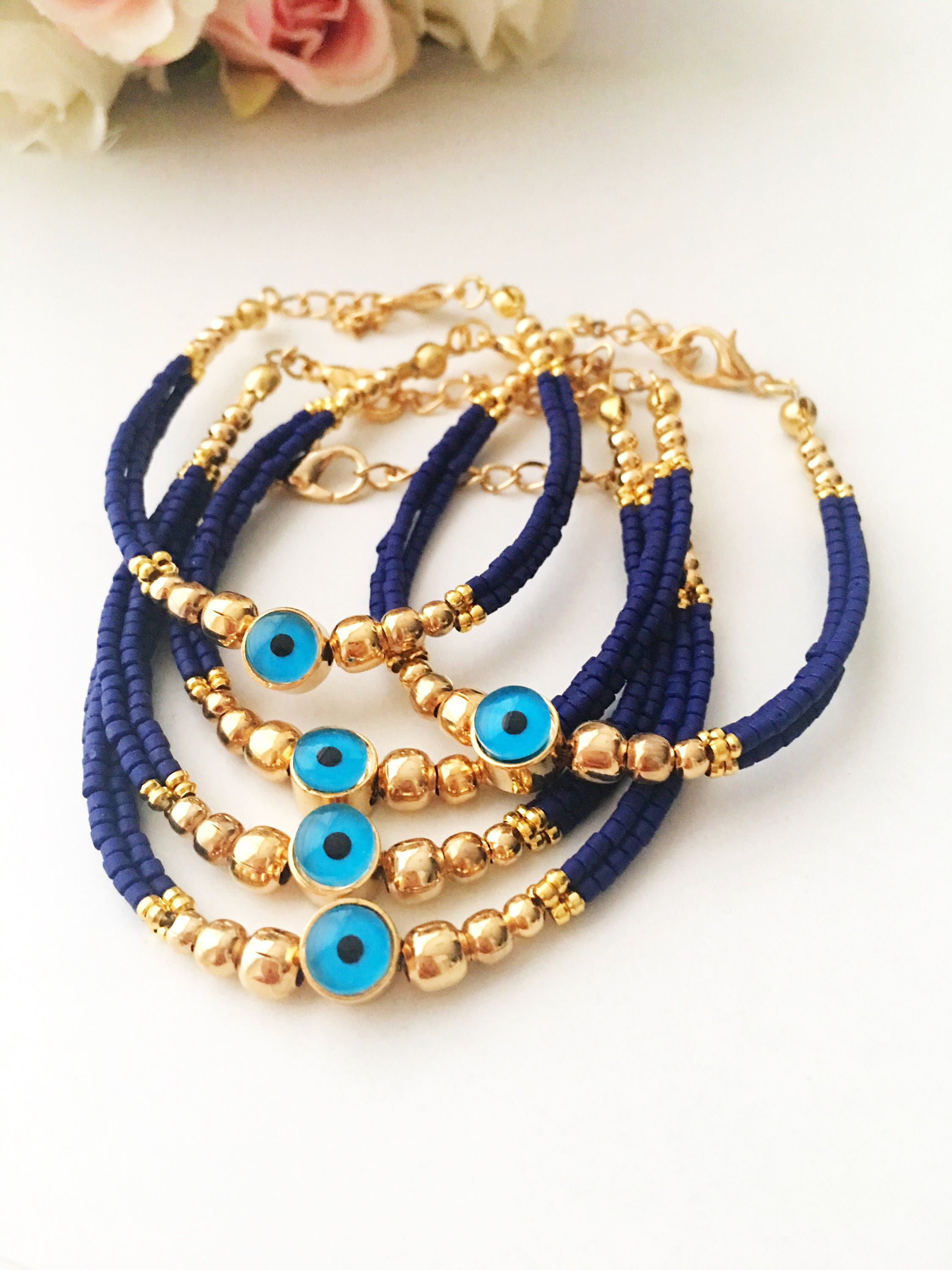 Handmade blue evil eye bracelet featuring Miyuki seed beads and a gold evil eye charm, symbolizing luck and protection.