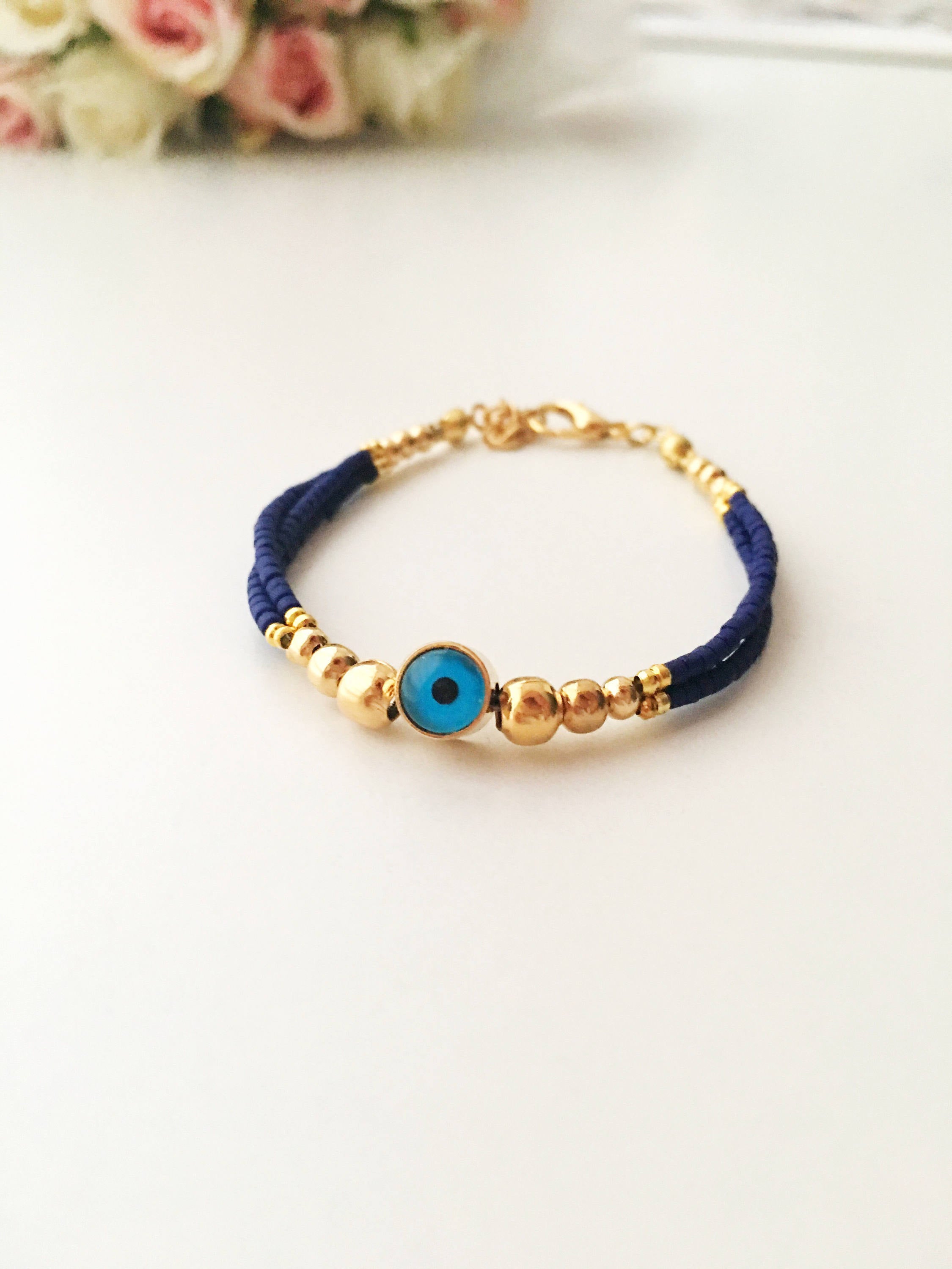 Handmade blue evil eye bracelet featuring Miyuki seed beads and a gold evil eye charm, symbolizing luck and protection.