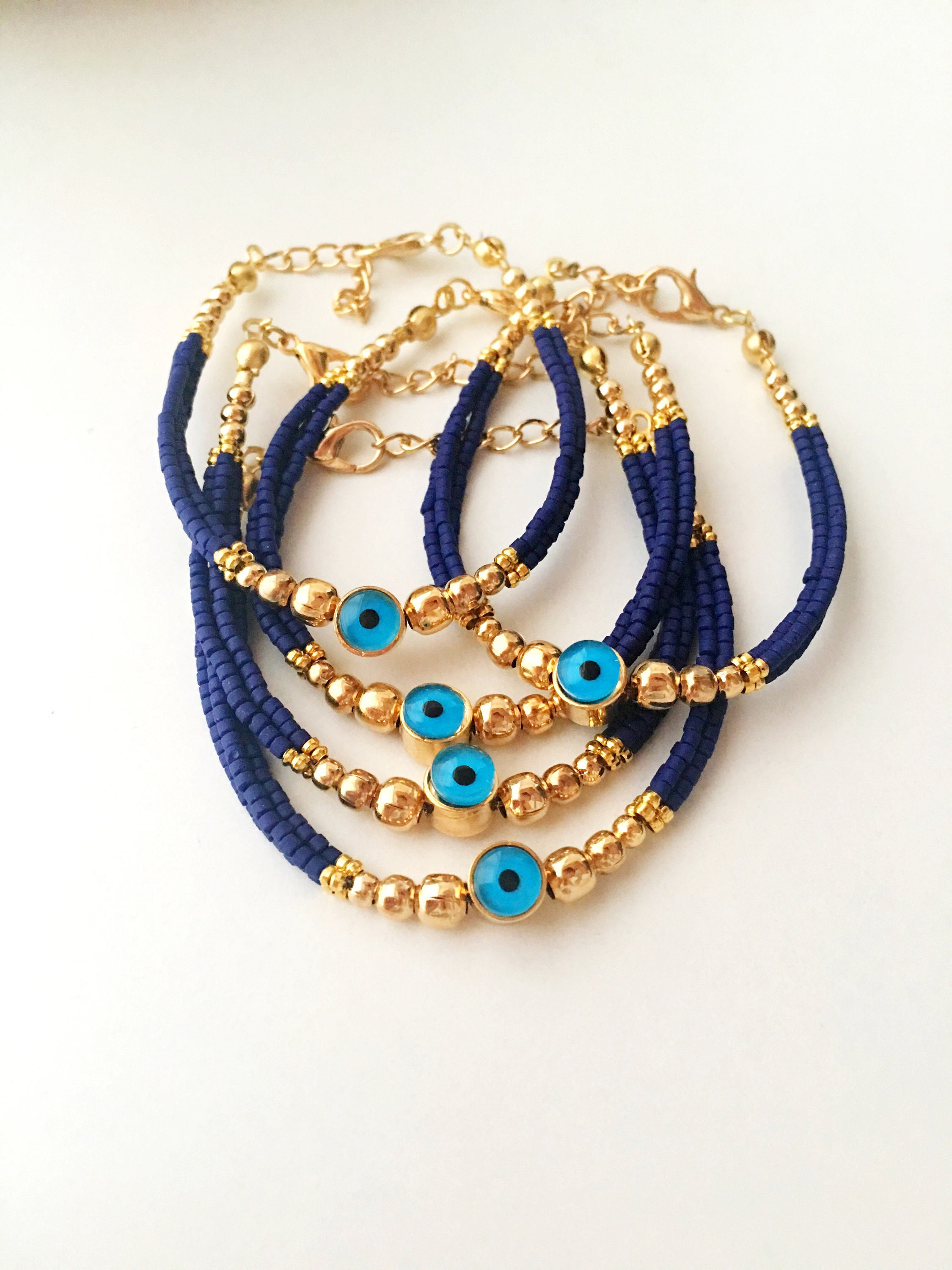 Handmade blue evil eye bracelet featuring Miyuki seed beads and a gold evil eye charm, symbolizing luck and protection.