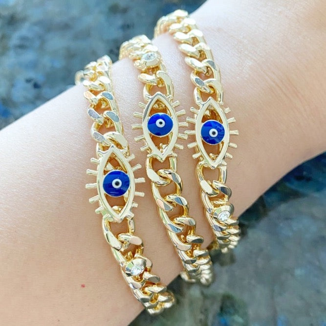 A stylish blue evil eye bracelet made of tarnish-resistant gold stainless steel, featuring a curb chain design and an adjustable fit.