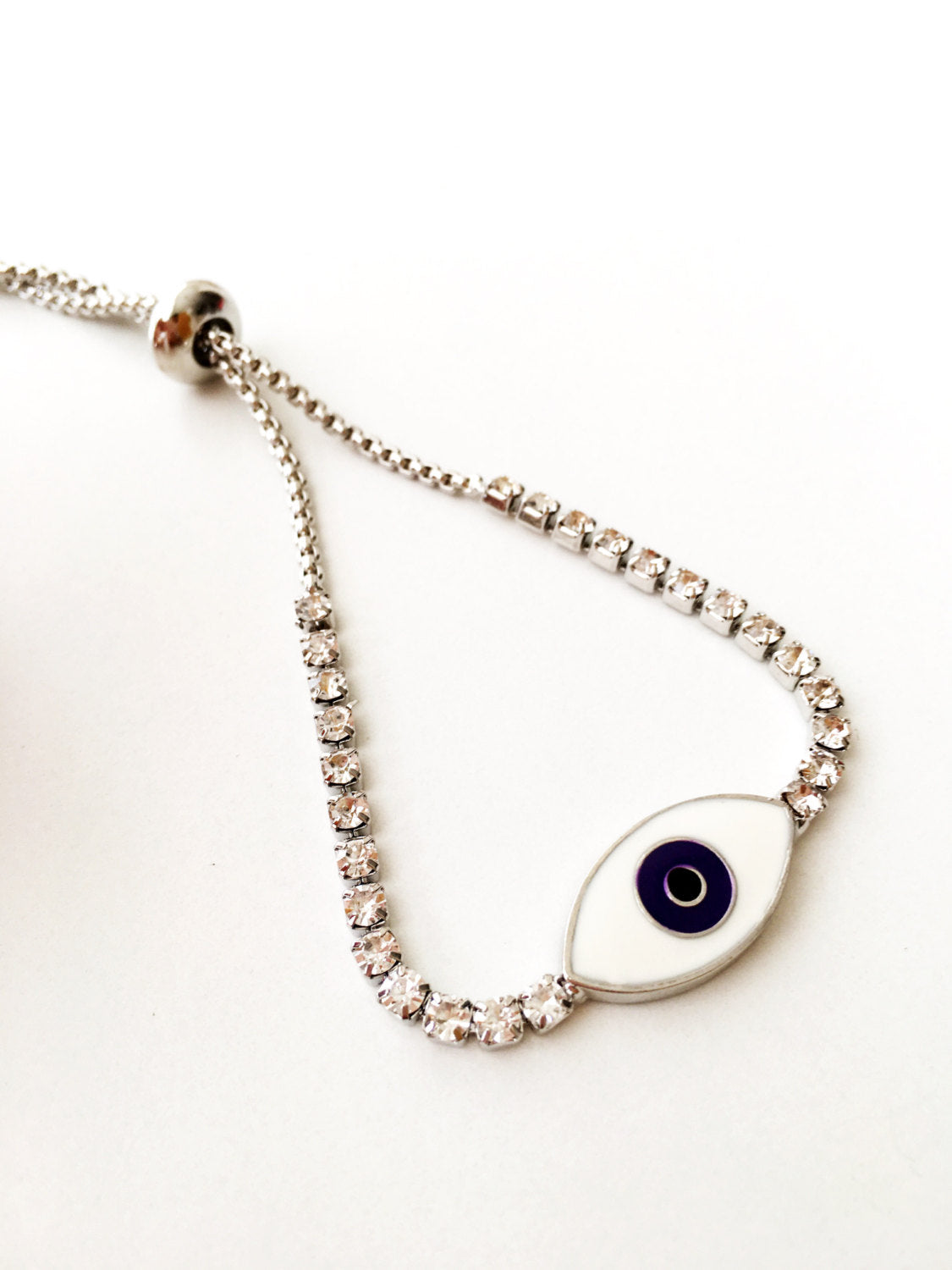 A beautiful Blue Evil Eye Bracelet made of stainless steel and zirconia, featuring an adjustable design for a perfect fit.