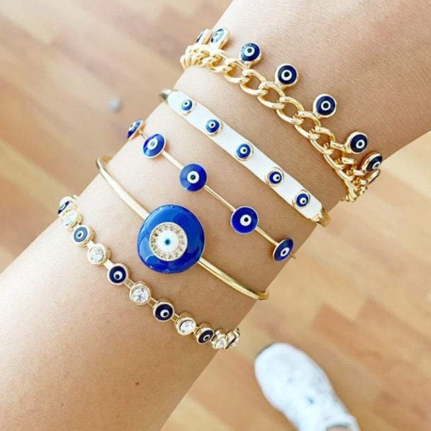 A beautiful blue evil eye bracelet made of gold stainless steel, showcasing its intricate design and water-resistant features.