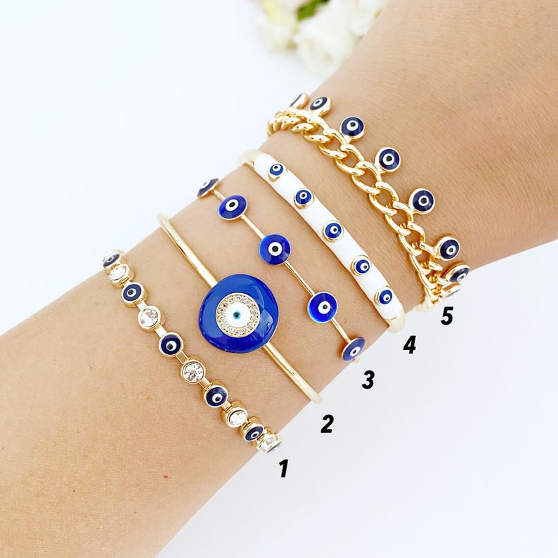 A beautiful blue evil eye bracelet made of gold stainless steel, showcasing its intricate design and water-resistant features.