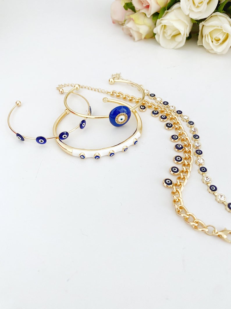 A beautiful blue evil eye bracelet made of gold stainless steel, showcasing its intricate design and water-resistant features.