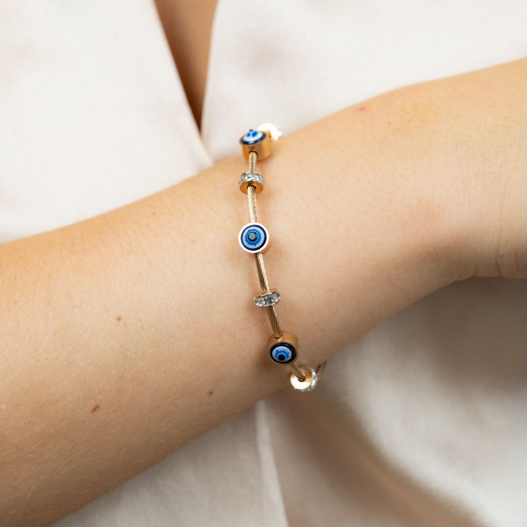 Blue Evil Eye Brass Gold Zircon Magnetic Bangle Bracelet featuring three evil eye charms in a radiant rose gold finish.