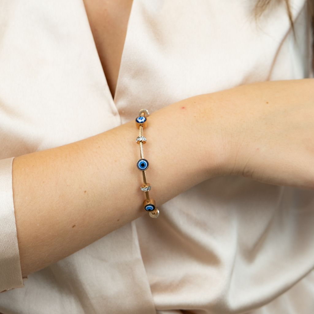 Blue Evil Eye Brass Gold Zircon Magnetic Bangle Bracelet featuring three evil eye charms in a radiant rose gold finish.