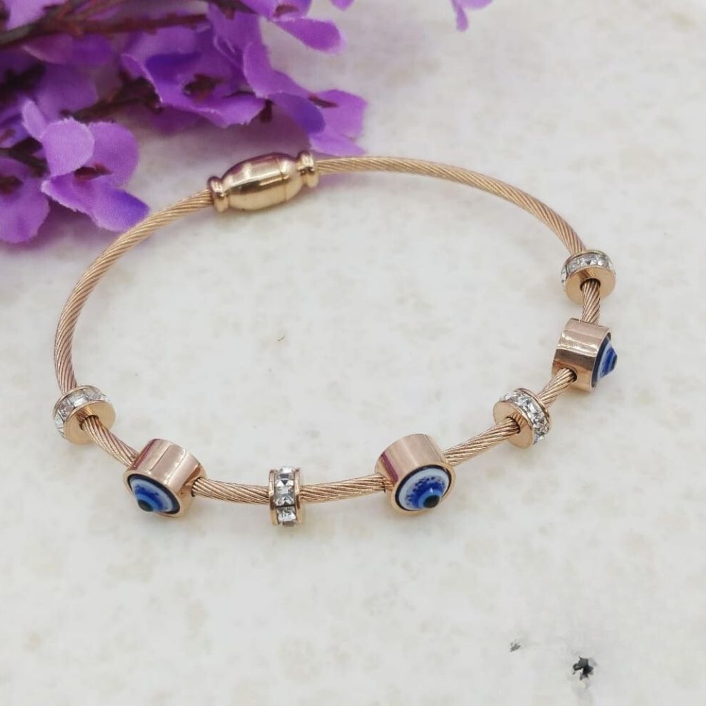 Blue Evil Eye Brass Gold Zircon Magnetic Bangle Bracelet featuring three evil eye charms in a radiant rose gold finish.