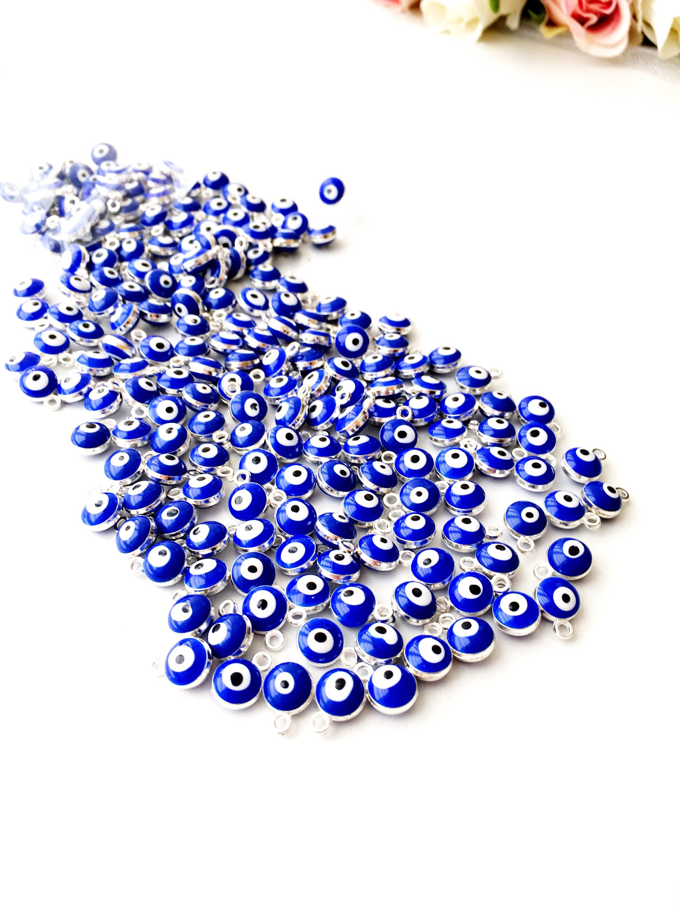 A collection of 10 blue evil eye charms made from brass, featuring a glossy enamel finish and a 2-sided design.