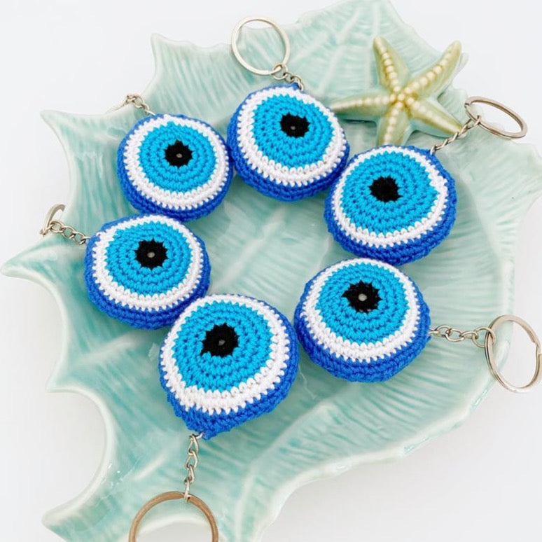 A beautifully handcrafted Blue Evil Eye Keychain made from cotton and silver, featuring a macrame design that symbolizes protection and good fortune.