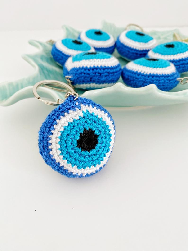 A beautifully handcrafted Blue Evil Eye Keychain made from cotton and silver, featuring a macrame design that symbolizes protection and good fortune.