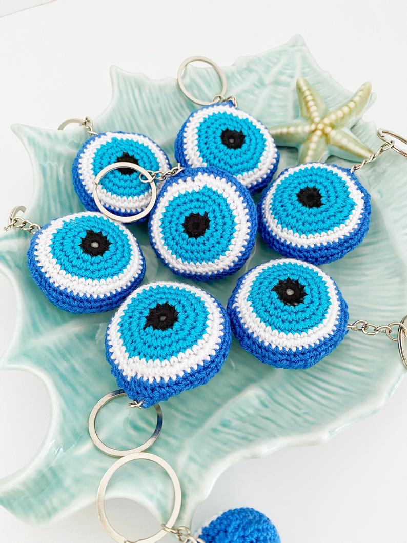 A beautifully handcrafted Blue Evil Eye Keychain made from cotton and silver, featuring a macrame design that symbolizes protection and good fortune.