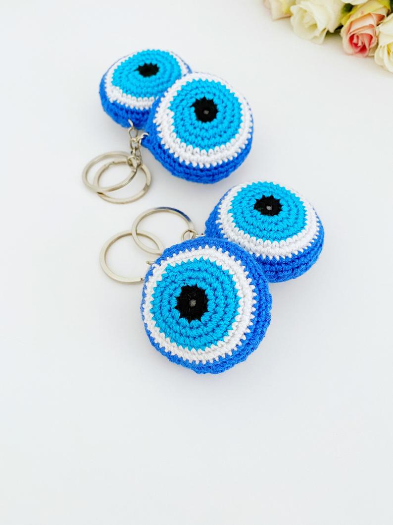 A beautifully handcrafted Blue Evil Eye Keychain made from cotton and silver, featuring a macrame design that symbolizes protection and good fortune.