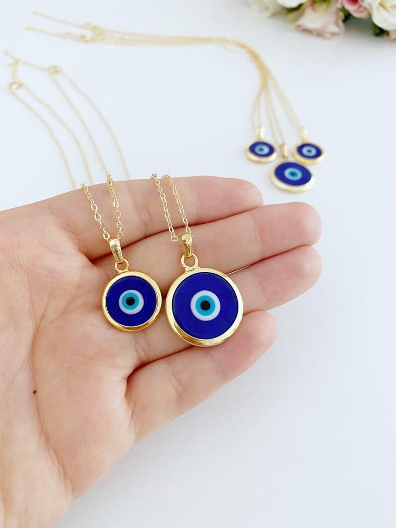 A beautiful Blue Evil Eye Necklace featuring a dark blue Murano glass bead on a gold stainless steel chain, symbolizing protection.