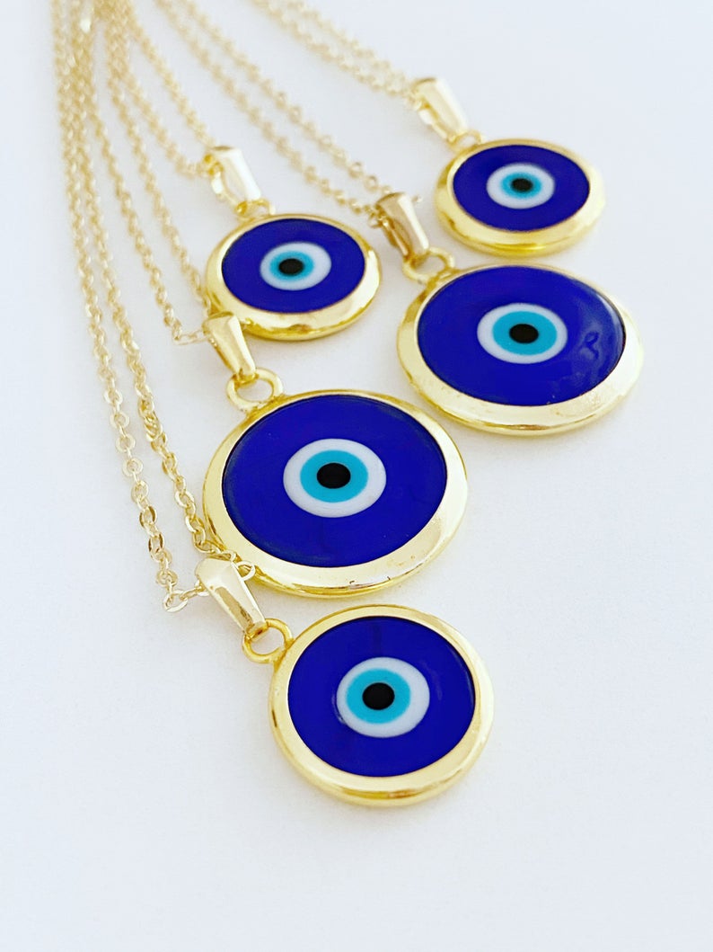 A beautiful Blue Evil Eye Necklace featuring a dark blue Murano glass bead on a gold stainless steel chain, symbolizing protection.