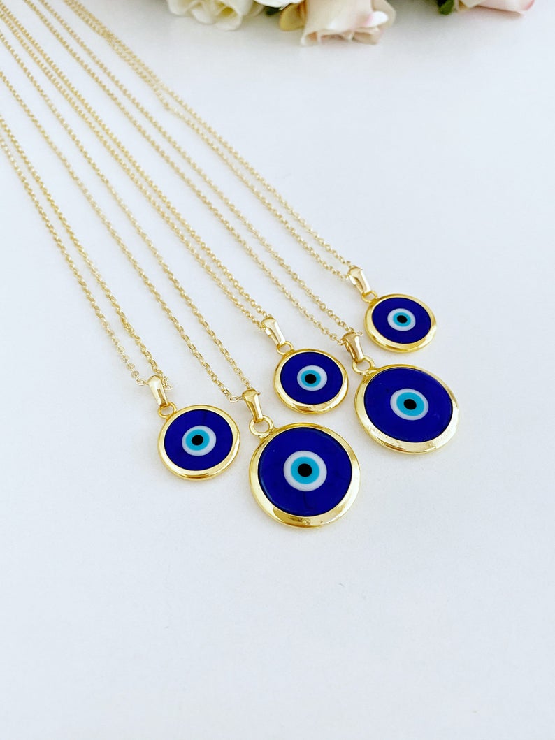 A beautiful Blue Evil Eye Necklace featuring a dark blue Murano glass bead on a gold stainless steel chain, symbolizing protection.