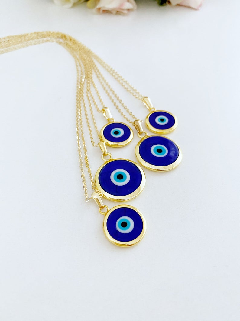 A beautiful Blue Evil Eye Necklace featuring a dark blue Murano glass bead on a gold stainless steel chain, symbolizing protection.