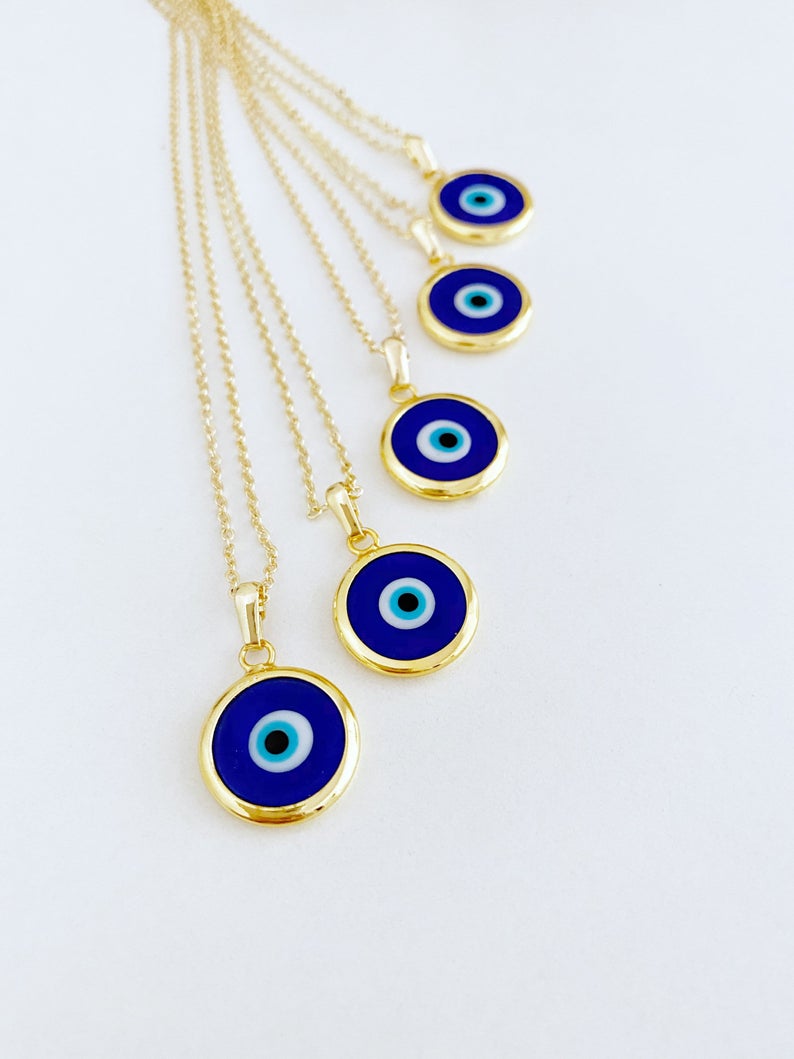 A beautiful Blue Evil Eye Necklace featuring a dark blue Murano glass bead on a gold stainless steel chain, symbolizing protection.