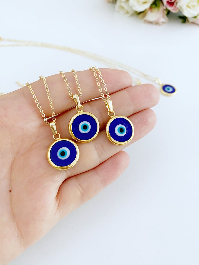 A beautiful Blue Evil Eye Necklace featuring a dark blue Murano glass bead on a gold stainless steel chain, symbolizing protection.