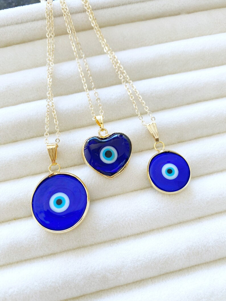 A beautiful Blue Evil Eye Necklace featuring a Murano glass bead and a gold stainless steel chain, showcasing intricate craftsmanship.