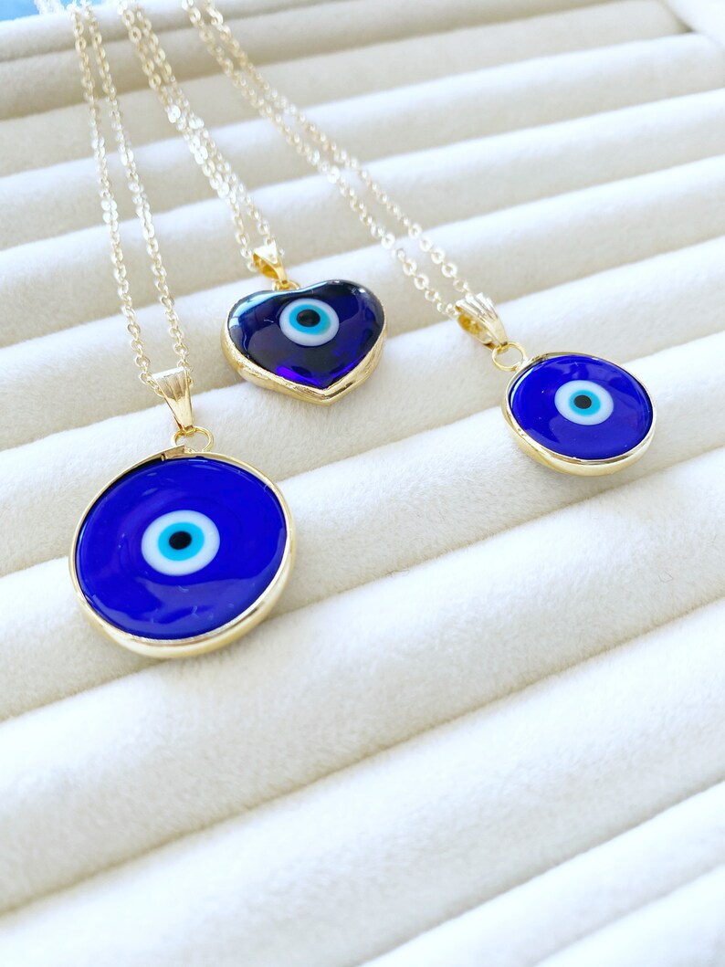 A beautiful Blue Evil Eye Necklace featuring a Murano glass bead and a gold stainless steel chain, showcasing intricate craftsmanship.