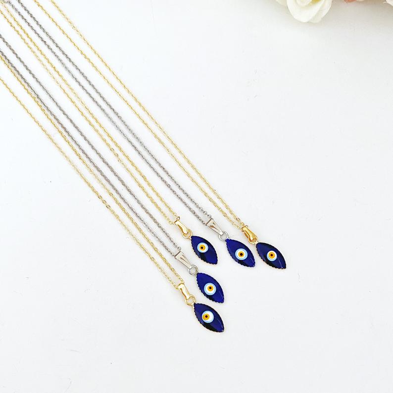 Handmade blue evil eye teardrop necklace with gold chain, symbolizing protection and luck.