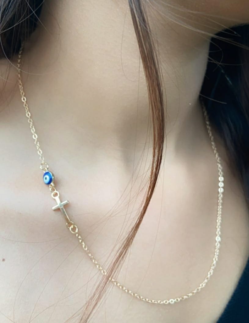 Blue Evil Eye Sideways Cross Necklace featuring a minimalist choker design with an evil eye bead and cross charm in gold and silver options.