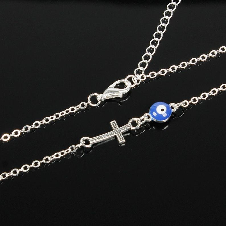 Blue Evil Eye Sideways Cross Necklace featuring a minimalist choker design with an evil eye bead and cross charm in gold and silver options.