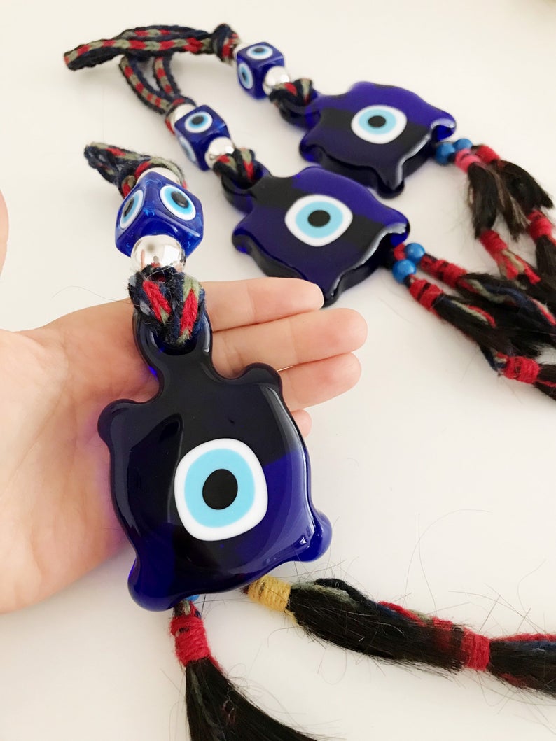 Blue Evil Eye Turtle Wall Hanging featuring a glass turtle bead and tiny evil eye beads, handcrafted with macrame for home decoration.