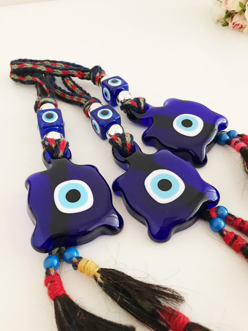 Blue Evil Eye Turtle Wall Hanging featuring a glass turtle bead and tiny evil eye beads, handcrafted with macrame for home decoration.