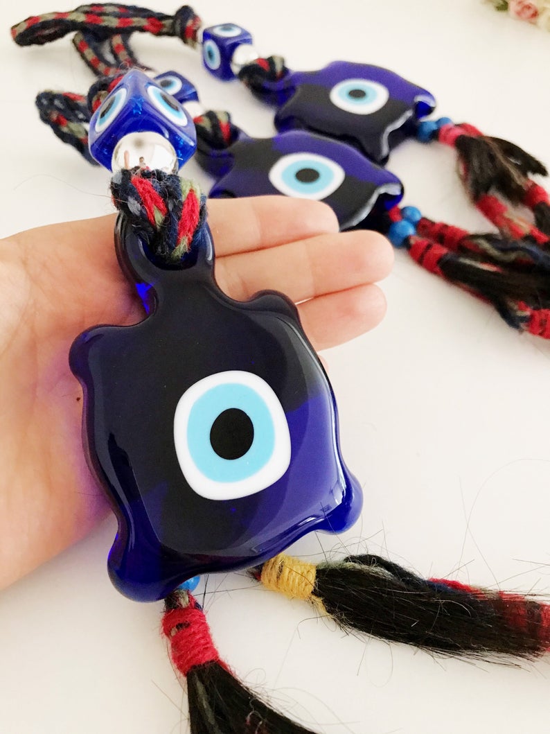 Blue Evil Eye Turtle Wall Hanging featuring a glass turtle bead and tiny evil eye beads, handcrafted with macrame for home decoration.