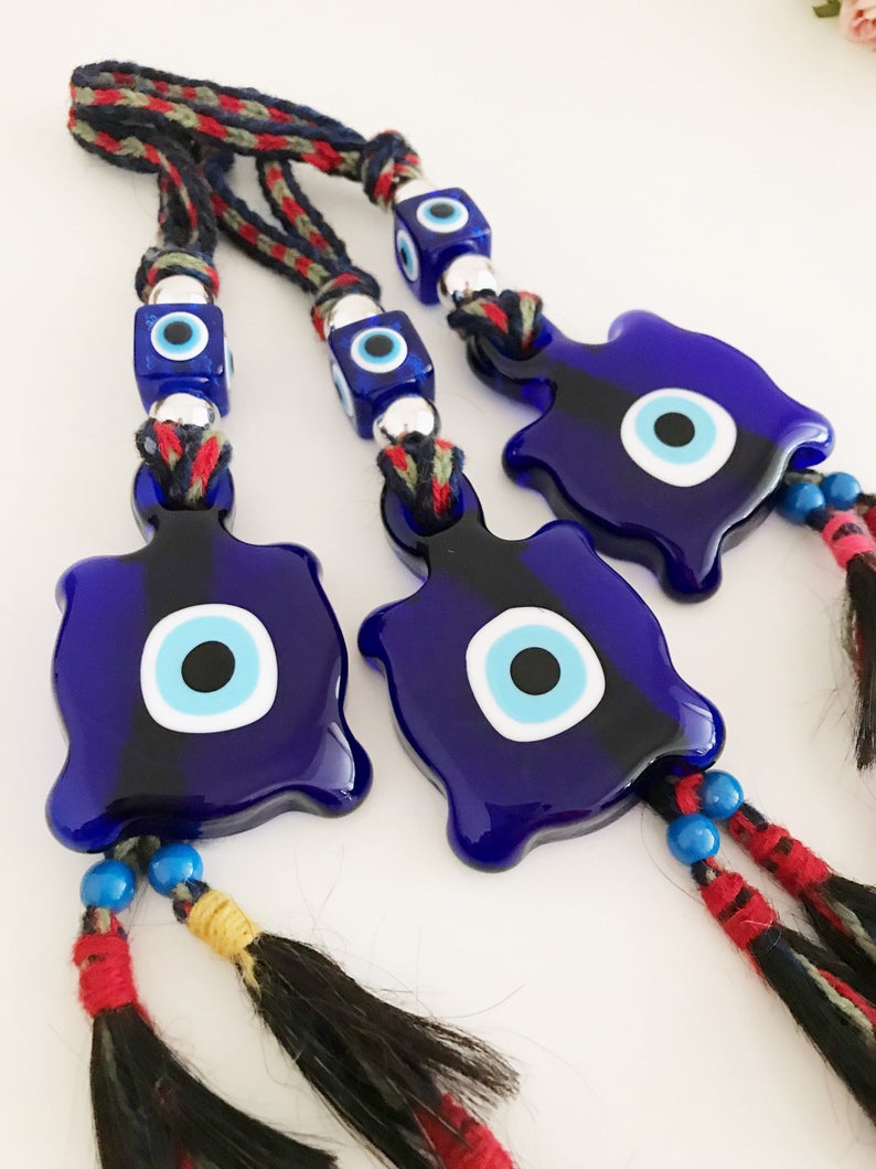 Blue Evil Eye Turtle Wall Hanging featuring a glass turtle bead and tiny evil eye beads, handcrafted with macrame for home decoration.