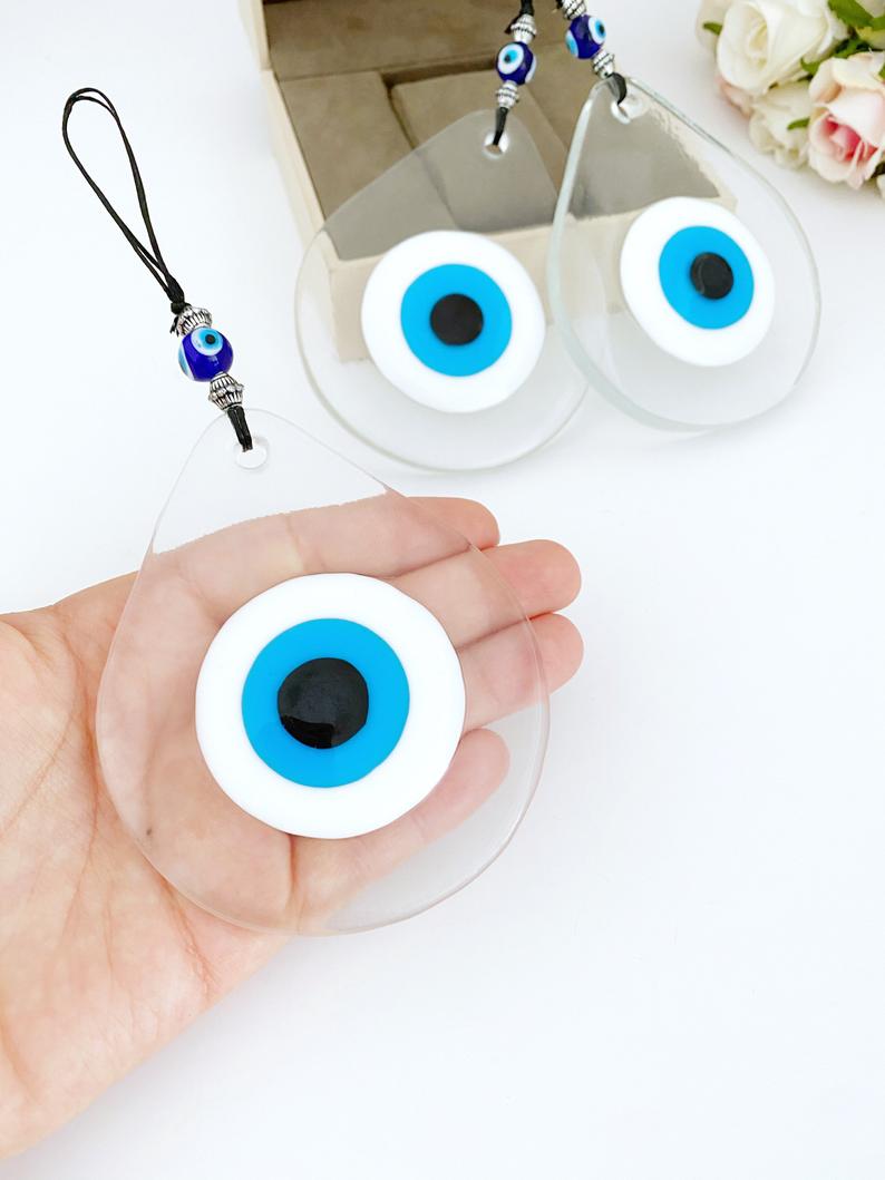 A beautiful handmade Blue Evil Eye Wall Hanging featuring a fused glass bead, symbolizing protection and good fortune.