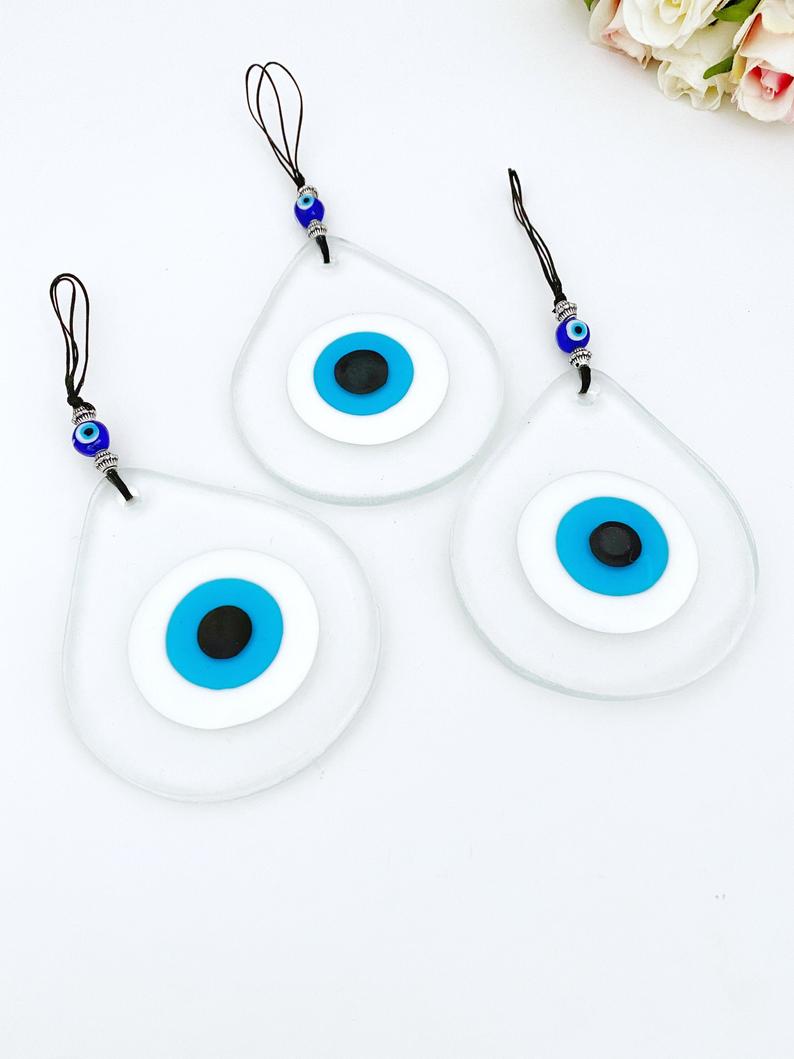 A beautiful handmade Blue Evil Eye Wall Hanging featuring a fused glass bead, symbolizing protection and good fortune.