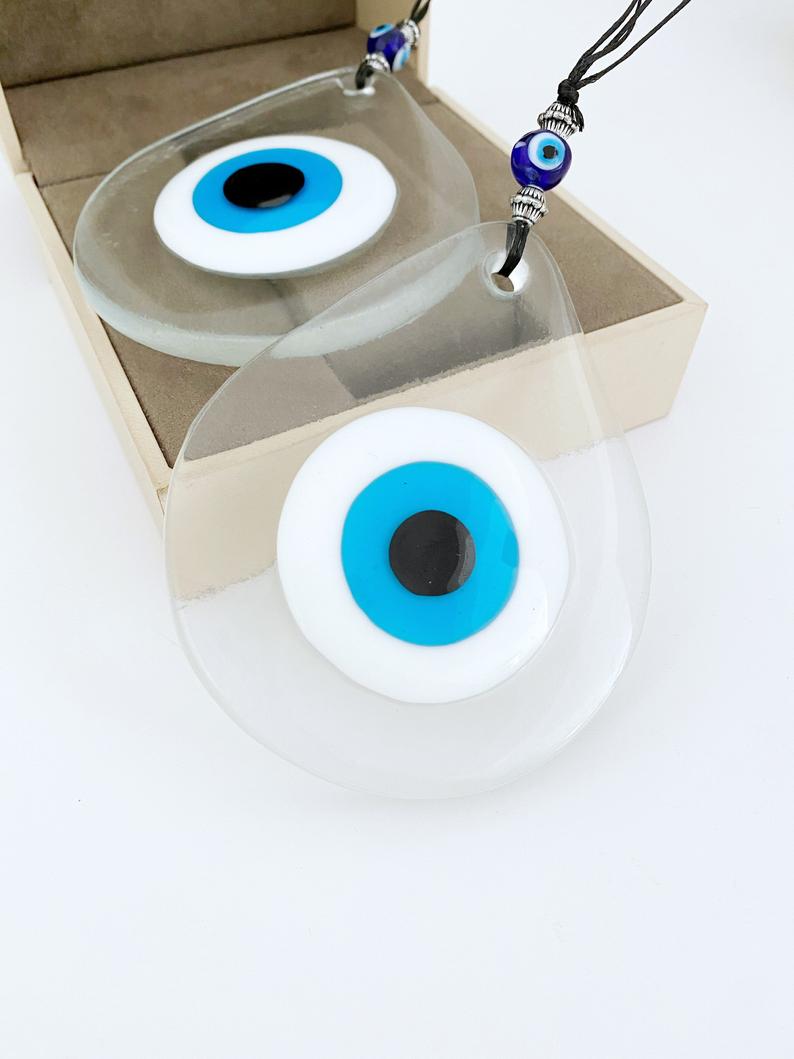 A beautiful handmade Blue Evil Eye Wall Hanging featuring a fused glass bead, symbolizing protection and good fortune.