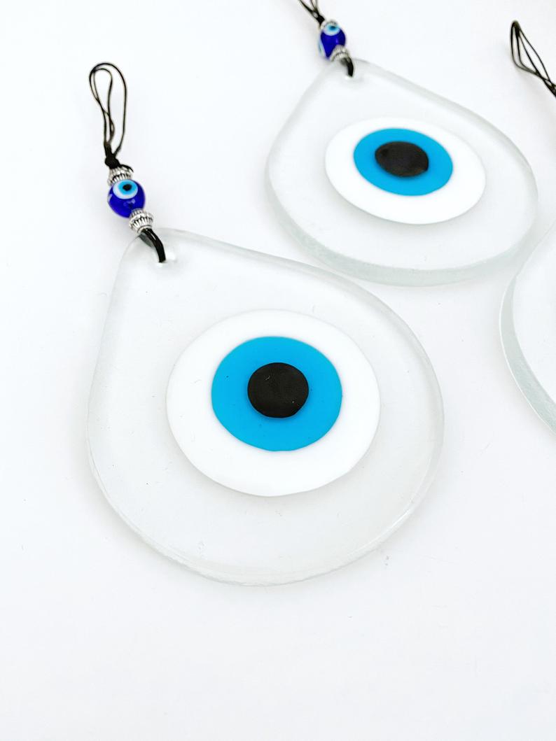 A beautiful handmade Blue Evil Eye Wall Hanging featuring a fused glass bead, symbolizing protection and good fortune.