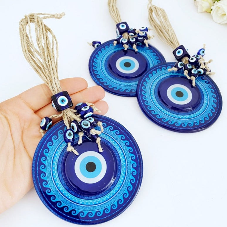 A beautifully handcrafted Blue Evil Eye Wall Hanging featuring a macrame design and a fused glass evil eye bead, perfect for home decor.