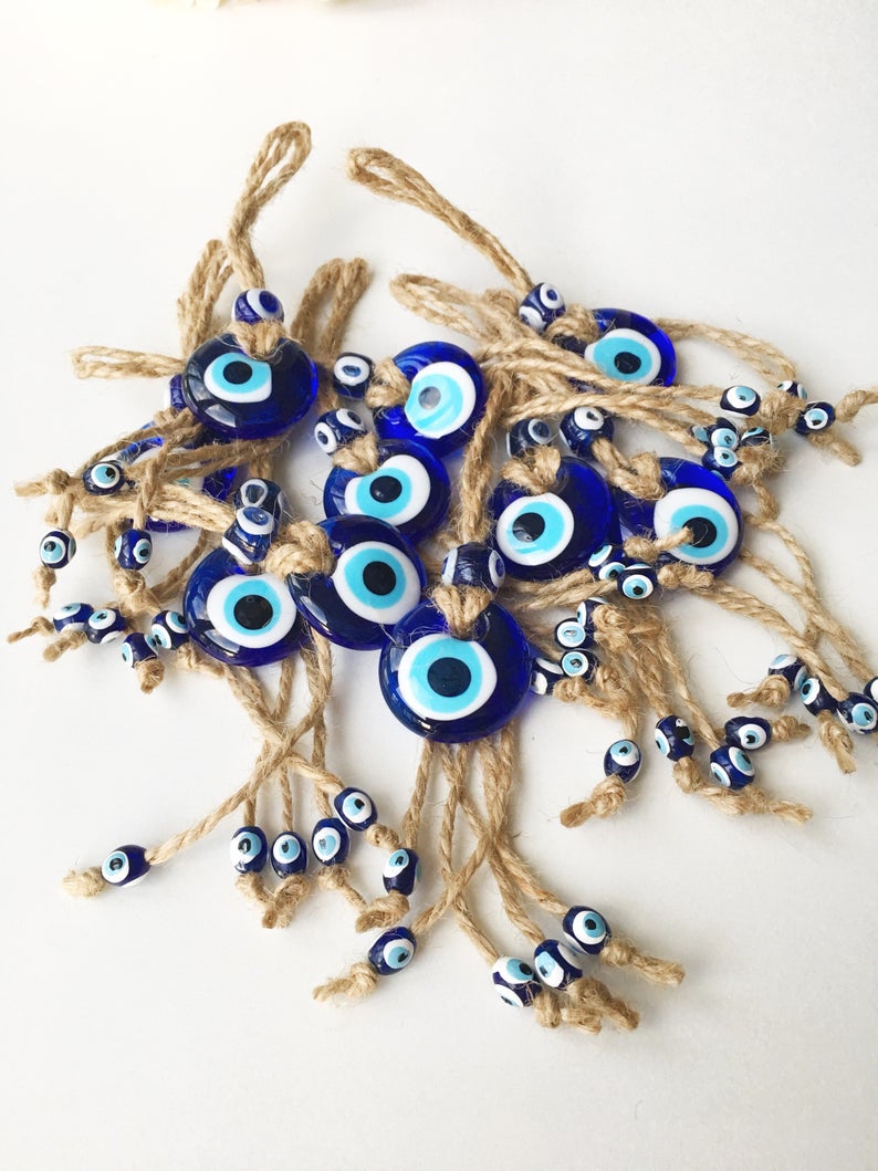 Small blue evil eye wall hanging with gold macrame, featuring a 3.5cm diameter evil eye bead, perfect for home decor and gifts.