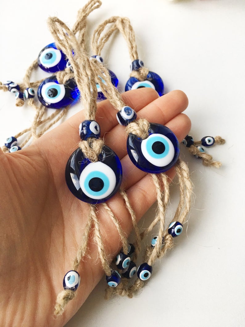 Small blue evil eye wall hanging with gold macrame, featuring a 3.5cm diameter evil eye bead, perfect for home decor and gifts.